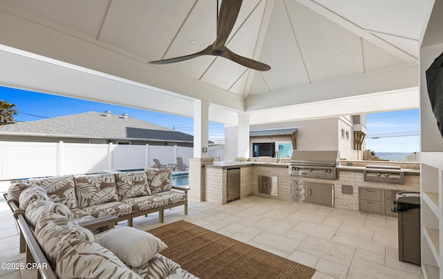 view of patio / terrace with ceiling fan, an outdoor hangout area, exterior kitchen, and area for grilling