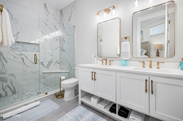 bathroom with an enclosed shower, vanity, and toilet