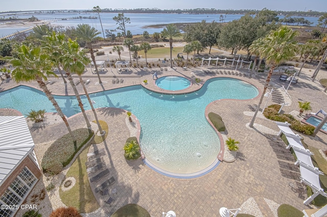 view of swimming pool with a water view, a hot tub, and a patio