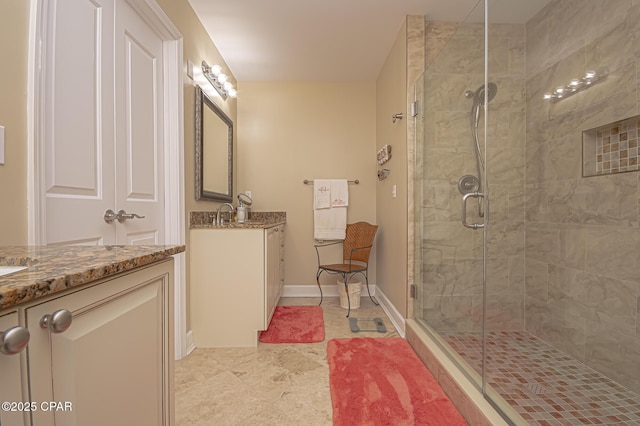 bathroom with a shower with door and vanity