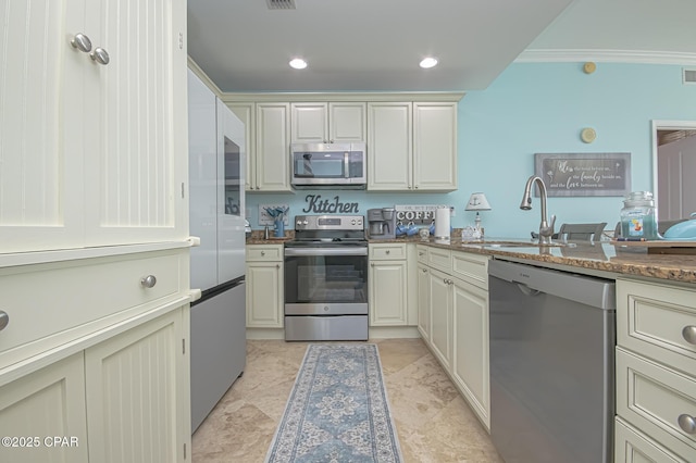 kitchen featuring stainless steel appliances, ornamental molding, and sink