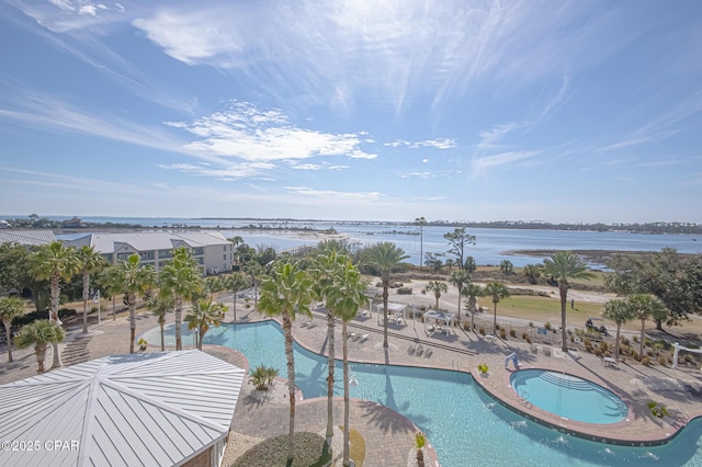 view of pool featuring a patio and a water view