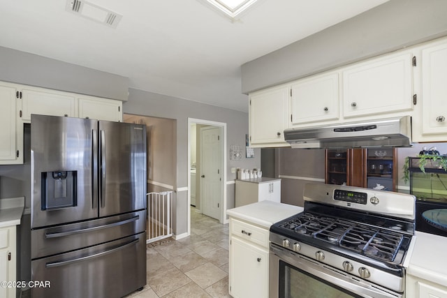 kitchen featuring stainless steel appliances and white cabinets