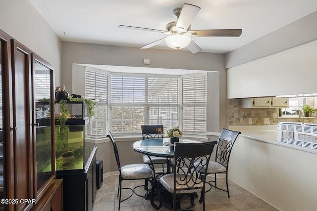 tiled dining area featuring a wealth of natural light and ceiling fan