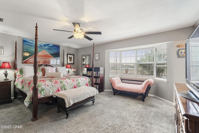 bedroom with ceiling fan, carpet flooring, and a textured ceiling