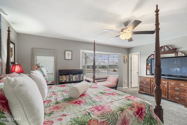 bedroom featuring ceiling fan, carpet, and a textured ceiling