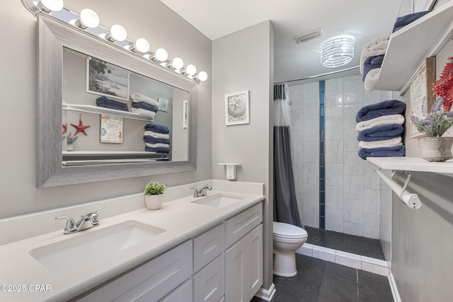 bathroom with tile patterned flooring, vanity, a shower with shower curtain, and toilet