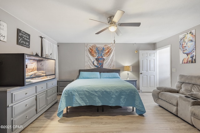 bedroom with ceiling fan and light hardwood / wood-style flooring