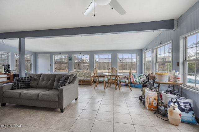 tiled living room with beamed ceiling and ceiling fan