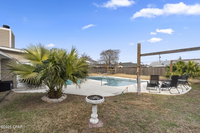 view of pool featuring central AC unit, a patio area, and a lawn