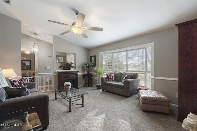 living room with vaulted ceiling, carpet, and ceiling fan