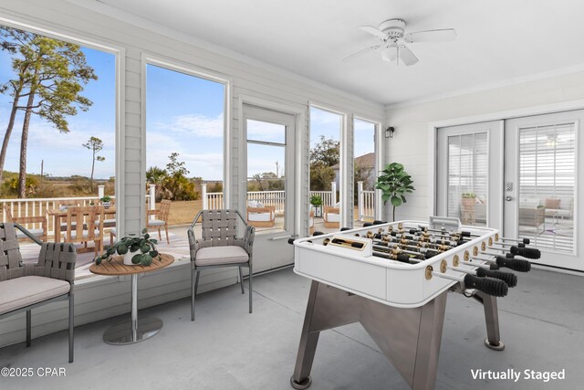 unfurnished sunroom with ceiling fan and french doors