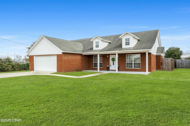 new england style home with a garage and a front yard