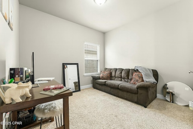 carpeted office space featuring lofted ceiling and baseboards