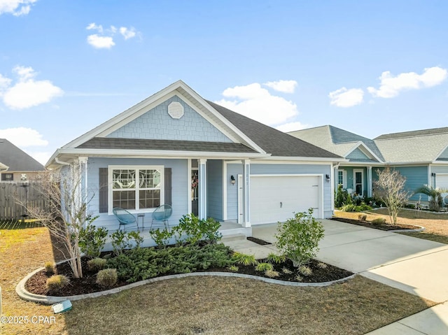 view of front of home featuring a garage, concrete driveway, roof with shingles, and fence