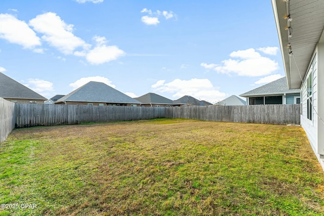 view of yard with a fenced backyard
