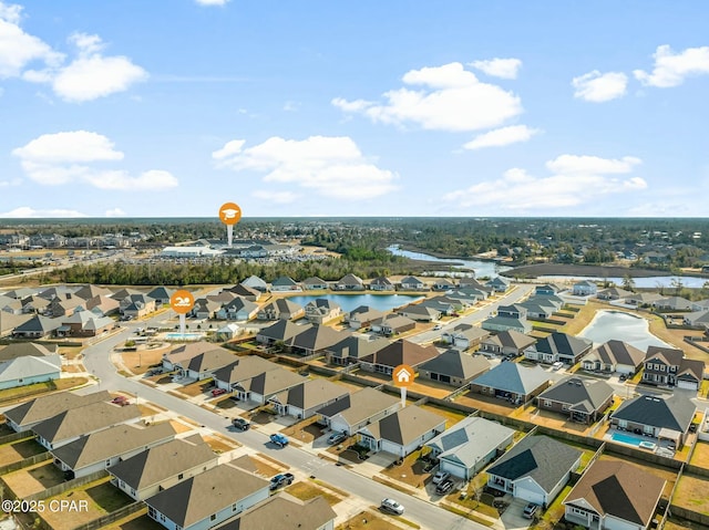 drone / aerial view featuring a water view and a residential view