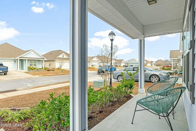 view of patio / terrace featuring a residential view and covered porch