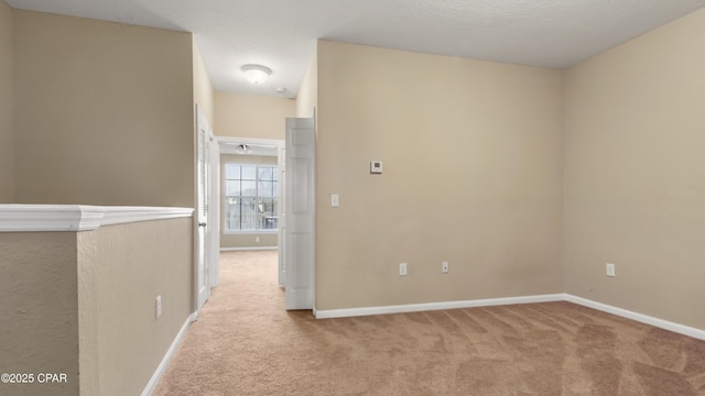 carpeted spare room with a textured ceiling