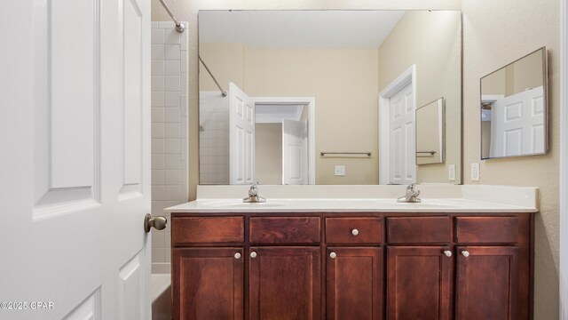 bathroom with vanity and a shower