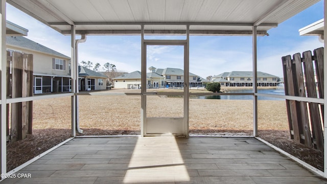 unfurnished sunroom with a water view