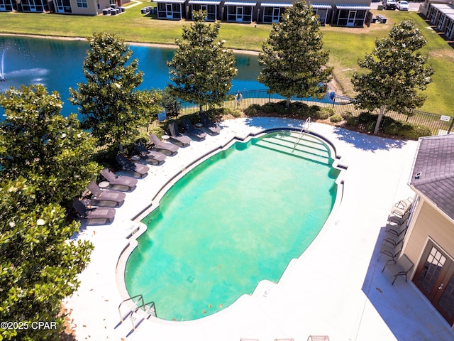 view of pool featuring a yard and a water view