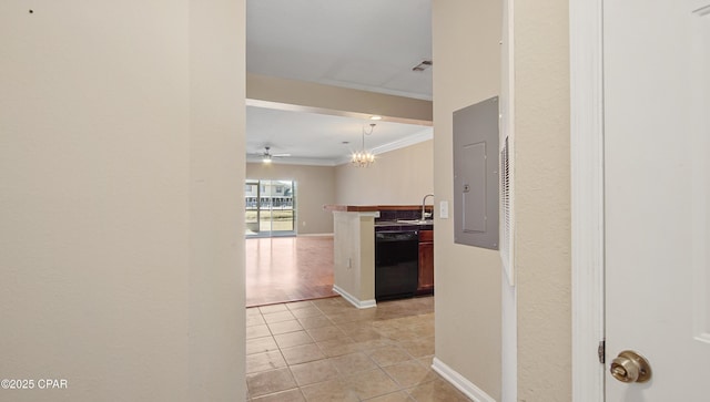 hallway featuring sink, crown molding, a chandelier, light tile patterned floors, and electric panel