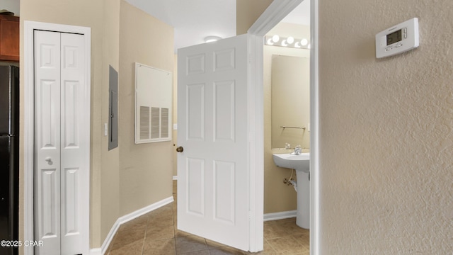 bathroom with tile patterned floors and electric panel