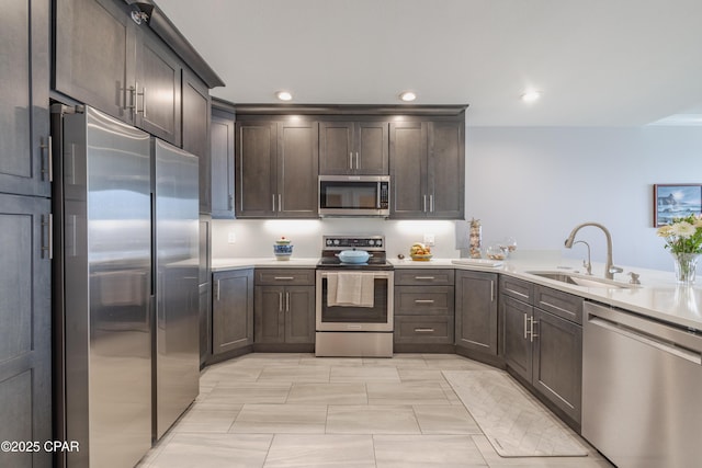 kitchen featuring sink, dark brown cabinets, and appliances with stainless steel finishes