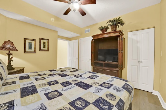 bedroom featuring visible vents, wood finished floors, and ceiling fan