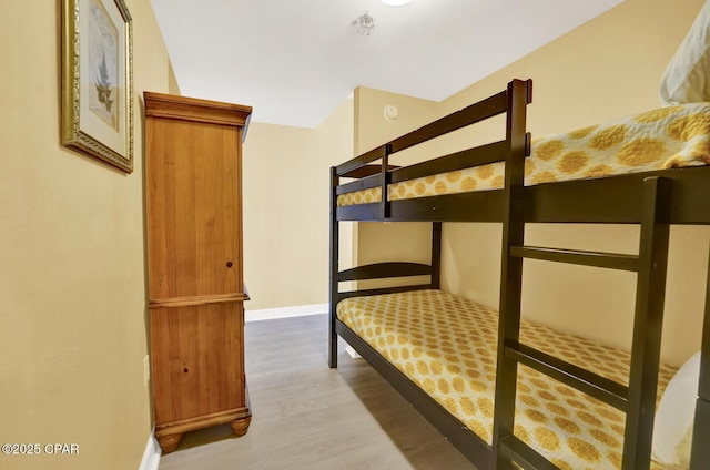 unfurnished bedroom featuring baseboards and wood finished floors