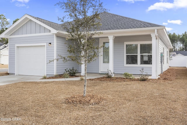 single story home featuring covered porch, a shingled roof, concrete driveway, a garage, and board and batten siding