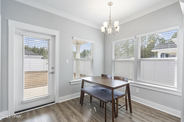 dining area with a wealth of natural light, baseboards, an inviting chandelier, and wood finished floors