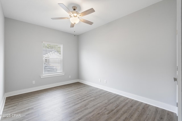 empty room featuring baseboards and wood finished floors