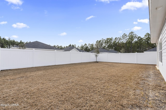 view of yard with a fenced backyard