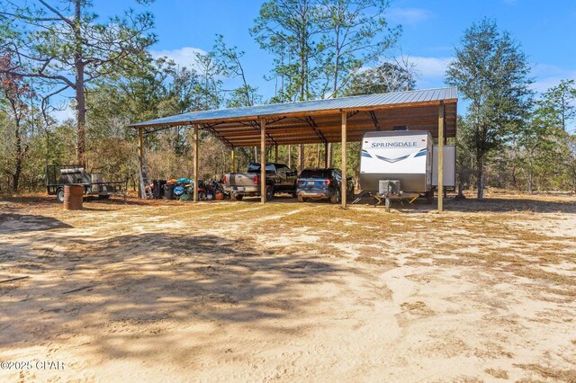 view of vehicle parking featuring a carport