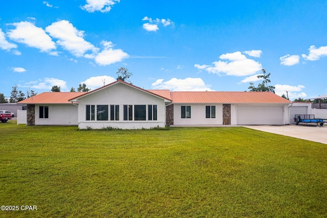 single story home with a garage and a front lawn