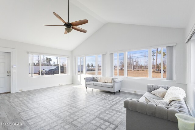 sunroom featuring vaulted ceiling, a wealth of natural light, and ceiling fan