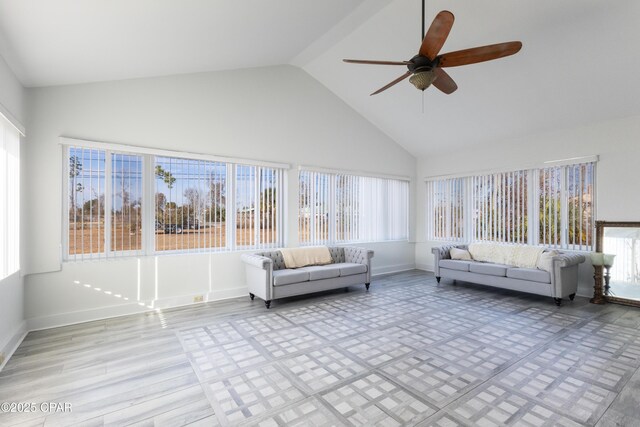 unfurnished sunroom with ceiling fan, lofted ceiling, and plenty of natural light