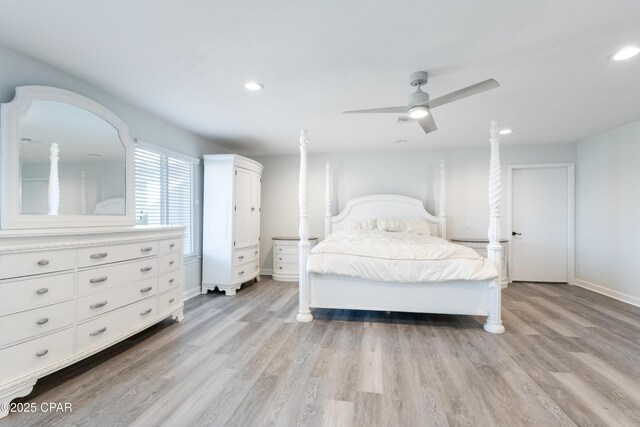 bedroom with light hardwood / wood-style floors and ceiling fan