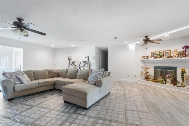 living room with ceiling fan and light hardwood / wood-style floors