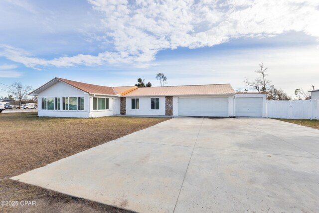 single story home featuring a garage and a front lawn