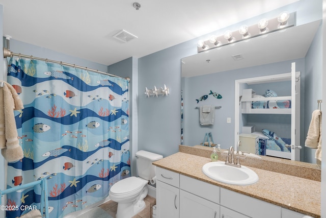 bathroom with vanity, tile patterned floors, toilet, and walk in shower