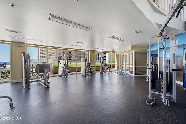 workout area with expansive windows and a textured ceiling