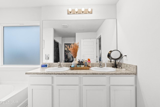 bathroom with vanity and a bathtub