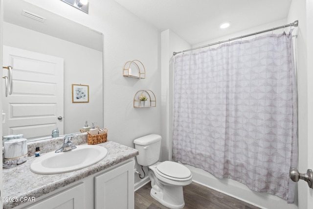 full bathroom with vanity, wood-type flooring, shower / bath combo with shower curtain, and toilet