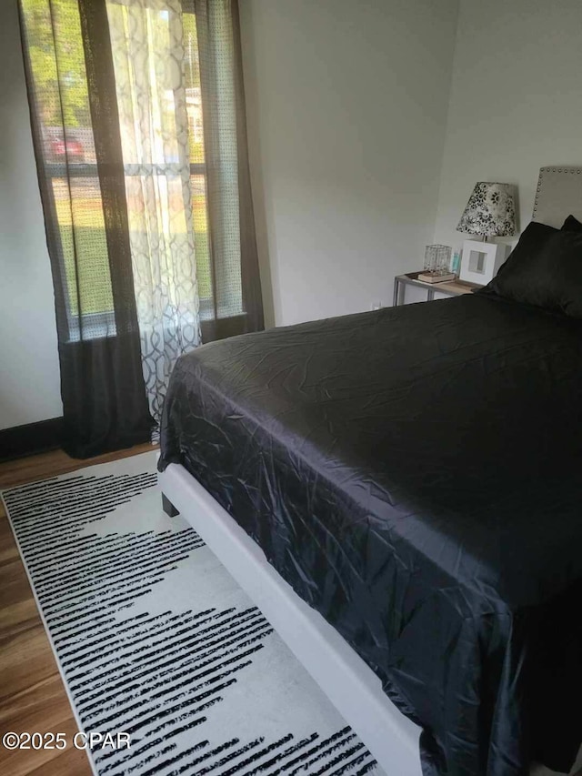 bedroom with hardwood / wood-style flooring