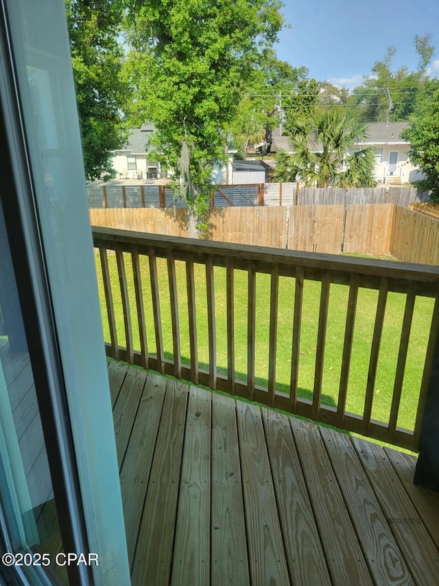 wooden terrace featuring a lawn