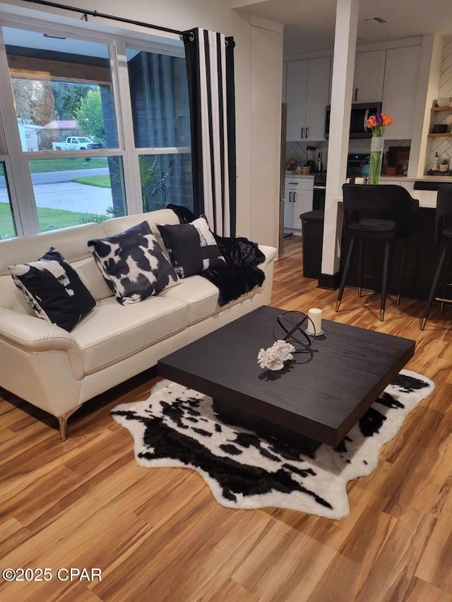 living room with light hardwood / wood-style flooring