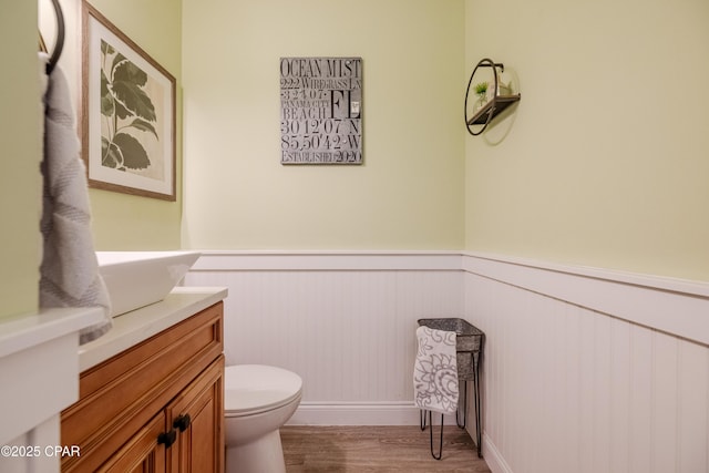 bathroom with vanity, hardwood / wood-style floors, and toilet